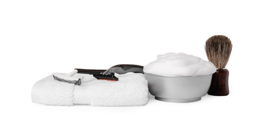 Photo of Shaving brush, foam, razors and towel on white background