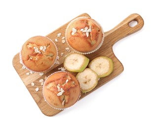 Photo of Wooden board with tasty muffins and banana slices on white background, top view