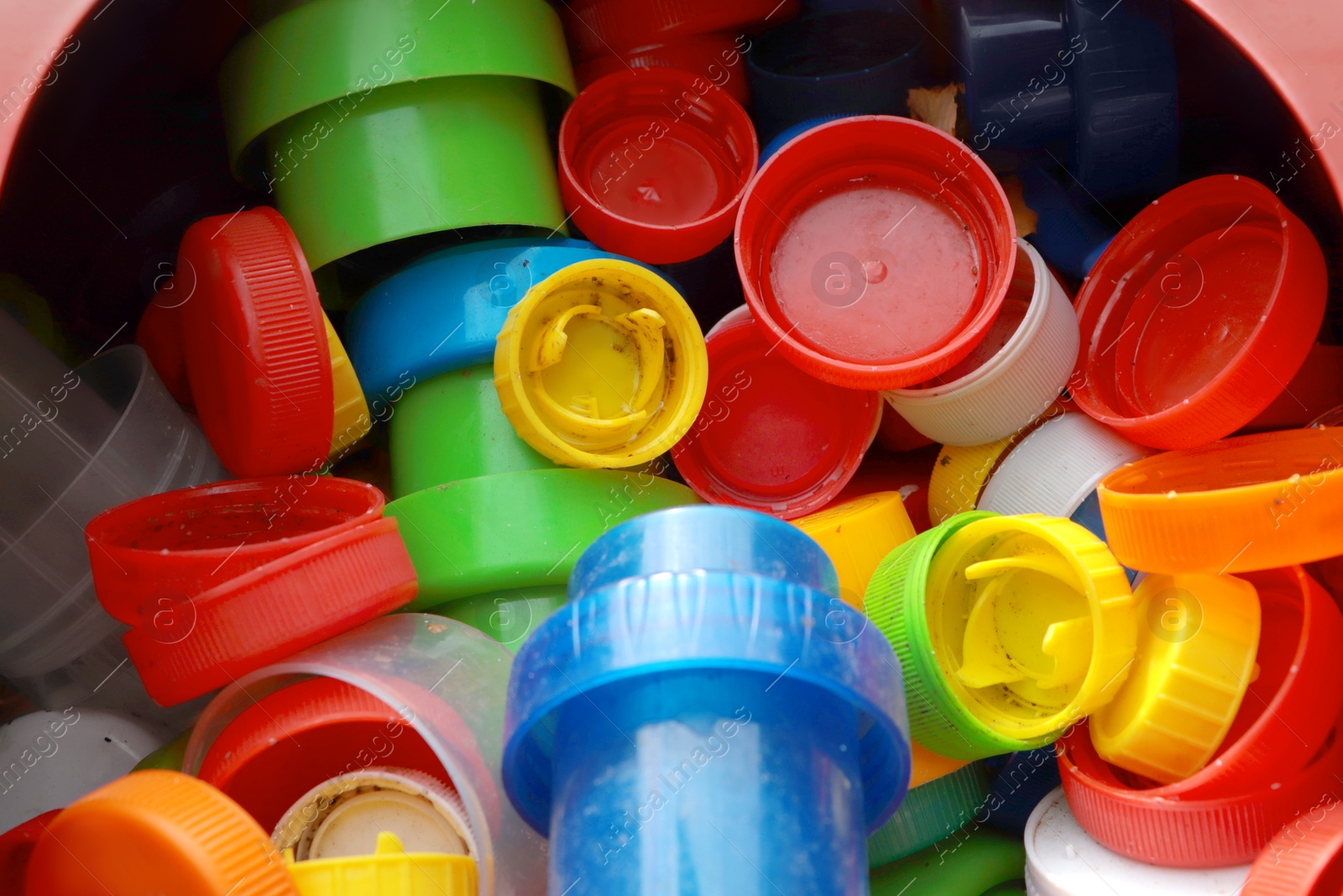 Photo of Different colorful bottle caps, closeup. Plastic recycling