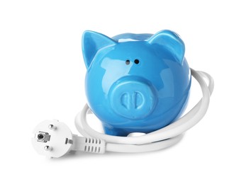 Photo of Blue piggy bank and power plug on white background. Energy saving concept