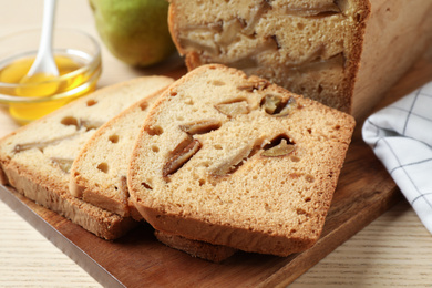 Tasty pear bread on wooden table, closeup. Homemade cake