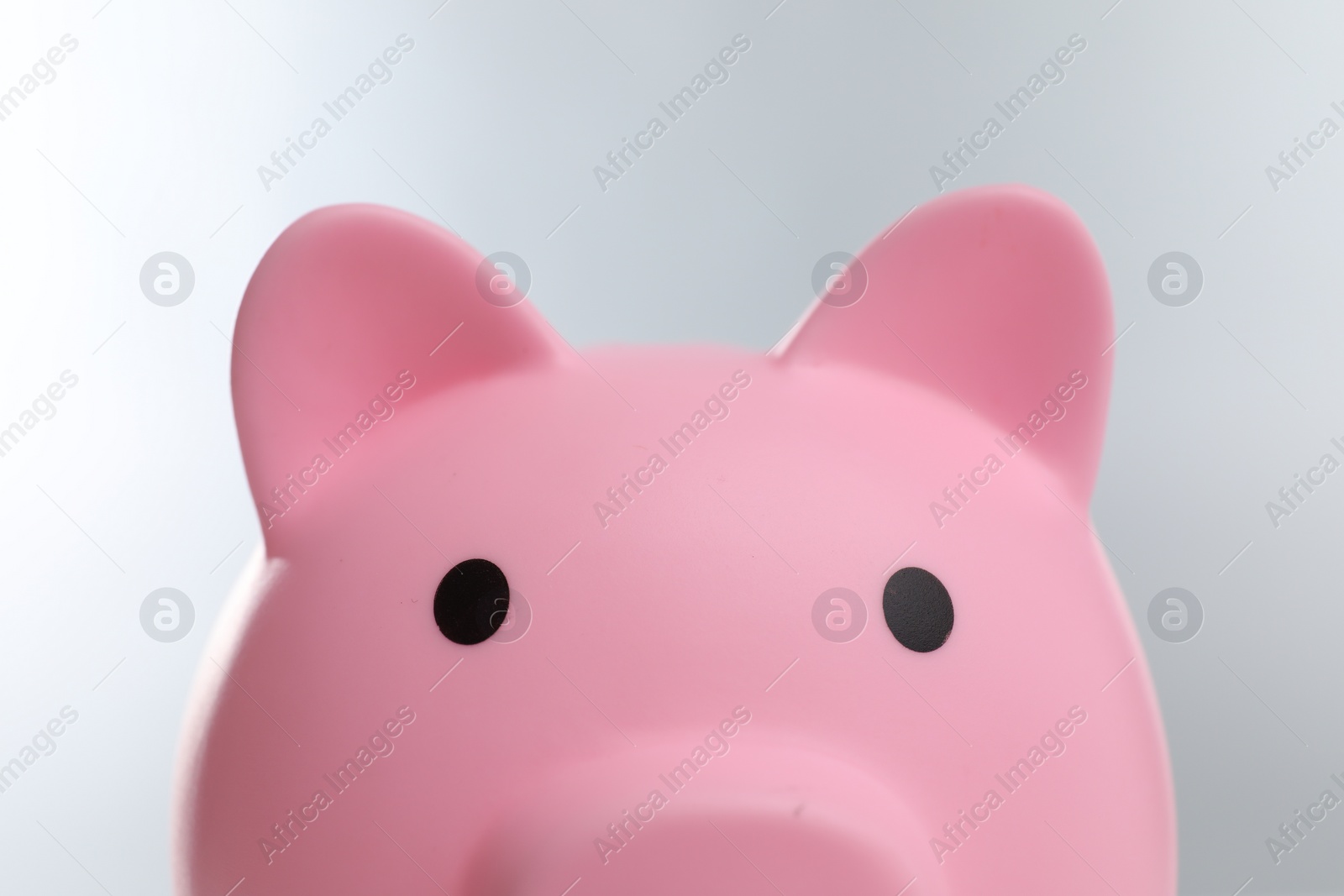 Photo of Pink piggy bank on grey background, closeup