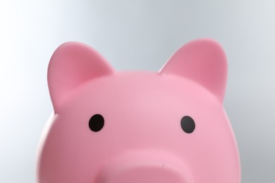 Photo of Pink piggy bank on grey background, closeup