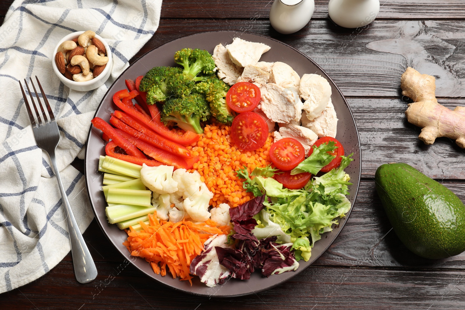 Photo of Balanced diet and healthy foods. Plate with different delicious products on dark wooden table, flat lay