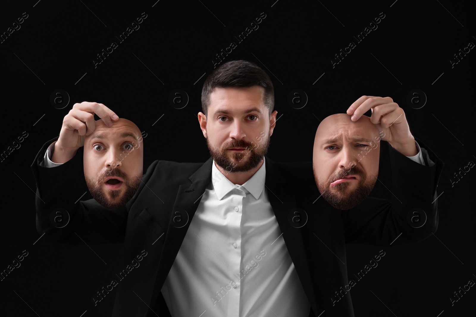Image of Man holding masks with his face showing different emotions on black background. Balanced personality