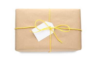 Photo of Parcel wrapped in kraft paper with tag on white background, top view