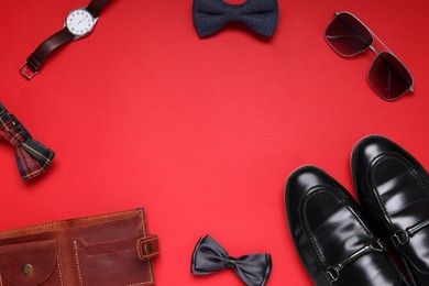 Photo of Flat lay composition with stylish bow ties, wristwatch and shoes on red background, space for text
