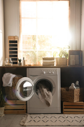 Photo of Stylish room interior with washing machine. Design idea