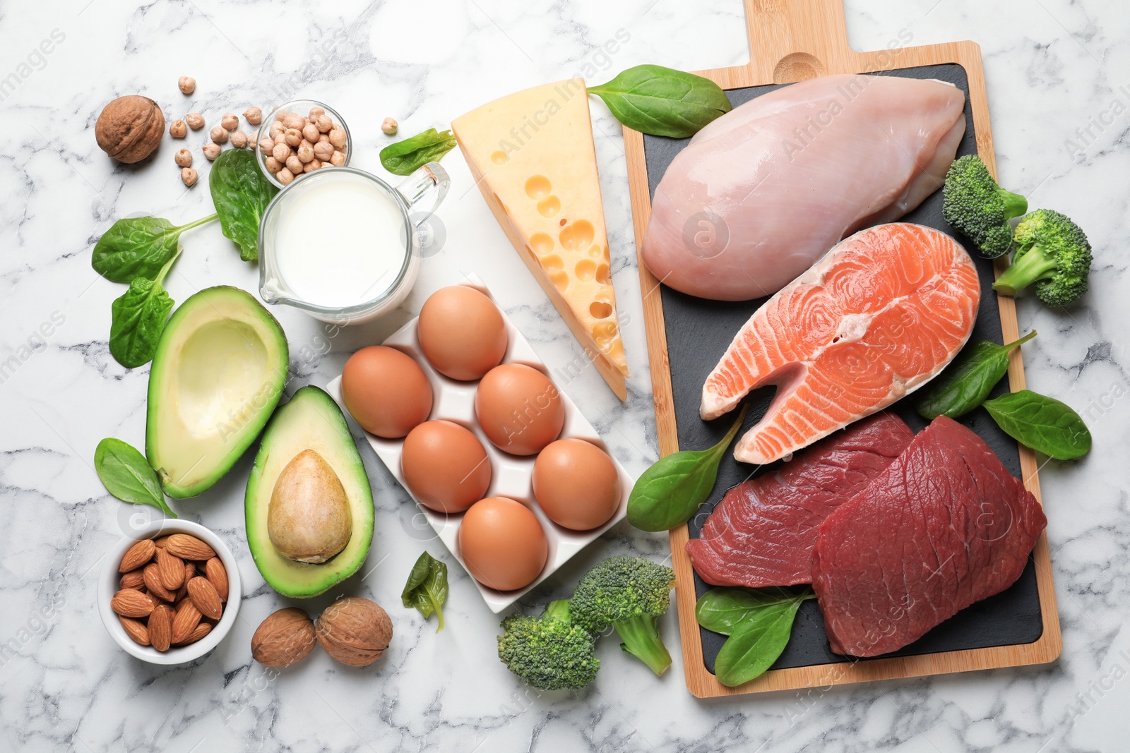 Photo of Set of natural food high in protein on marble background, top view