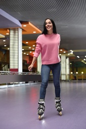 Photo of Young woman spending time at roller skating rink