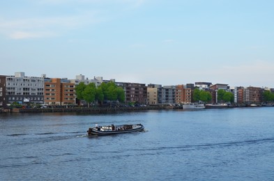 Photo of Beautiful view of cityscape with boat on river