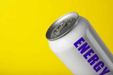 Can of energy drink on yellow background