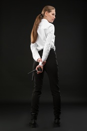 Photo of Female security guard with portable radio transmitter on dark background