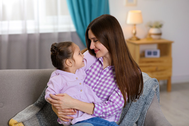 Young mother with little daughter at home