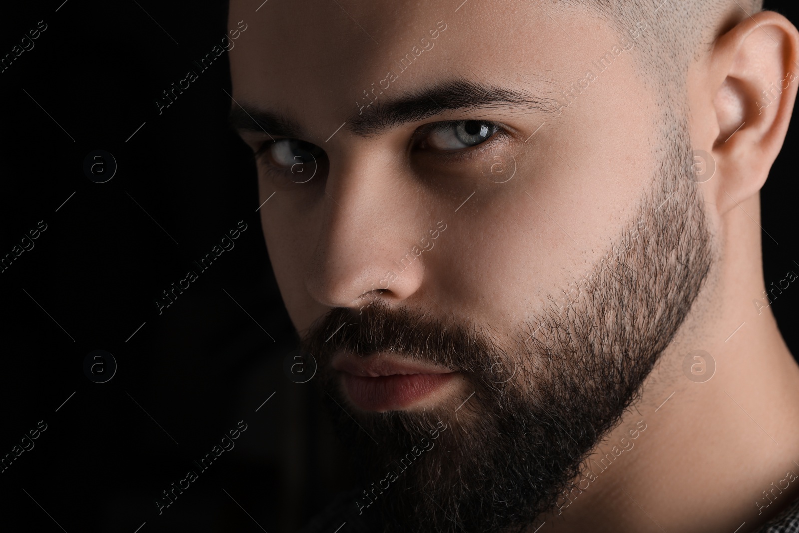 Photo of Evil eye. Man with scary eyes on black background