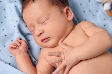 Cute newborn baby sleeping on bed, closeup