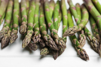 Fresh raw asparagus on white table, closeup