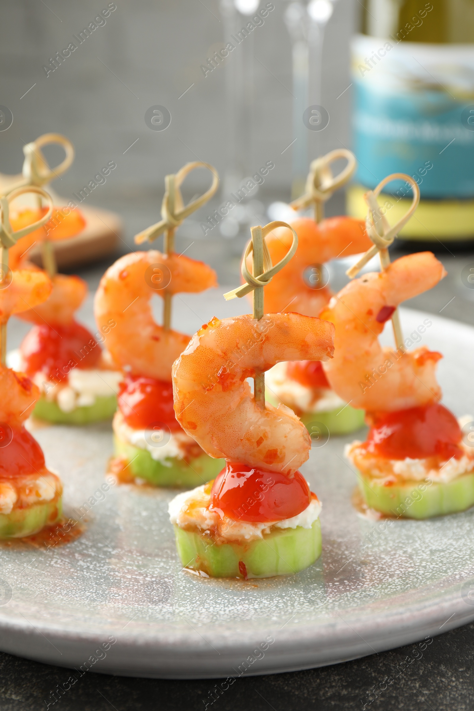 Photo of Tasty canapes with shrimps, vegetables and cream cheese on table, closeup