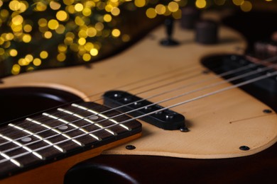 Photo of Closeup view of guitar against blurred lights