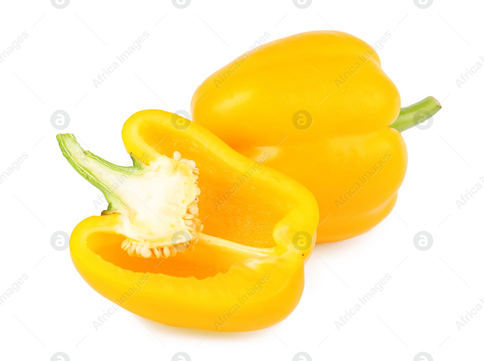 Photo of Whole and cut yellow bell peppers isolated on white