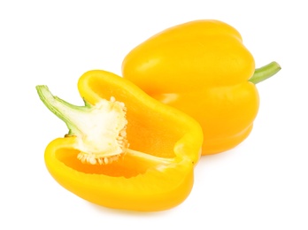 Photo of Whole and cut yellow bell peppers isolated on white