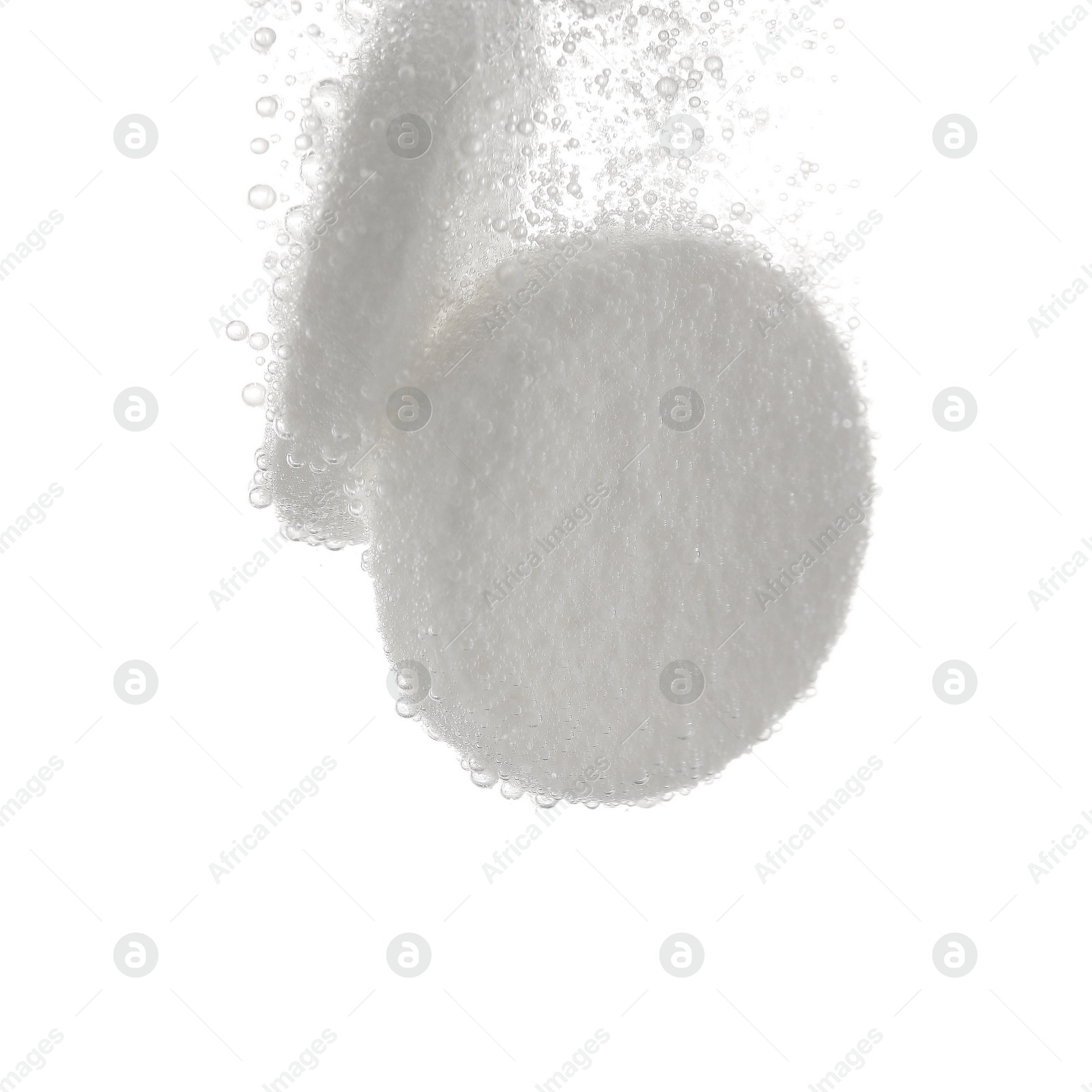 Photo of Effervescent pills dissolving in water on white background, closeup