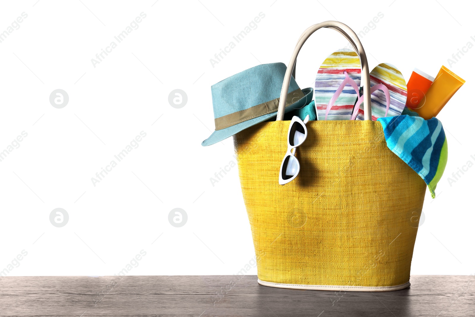 Photo of Composition with different beach objects on wooden table, white background