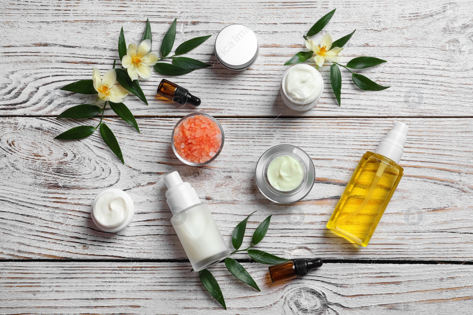 Photo of Flat lay composition with cosmetic products on wooden background