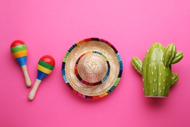 Photo of Colorful maracas, toy cactus and sombrero hat on pink background, flat lay. Musical instrument
