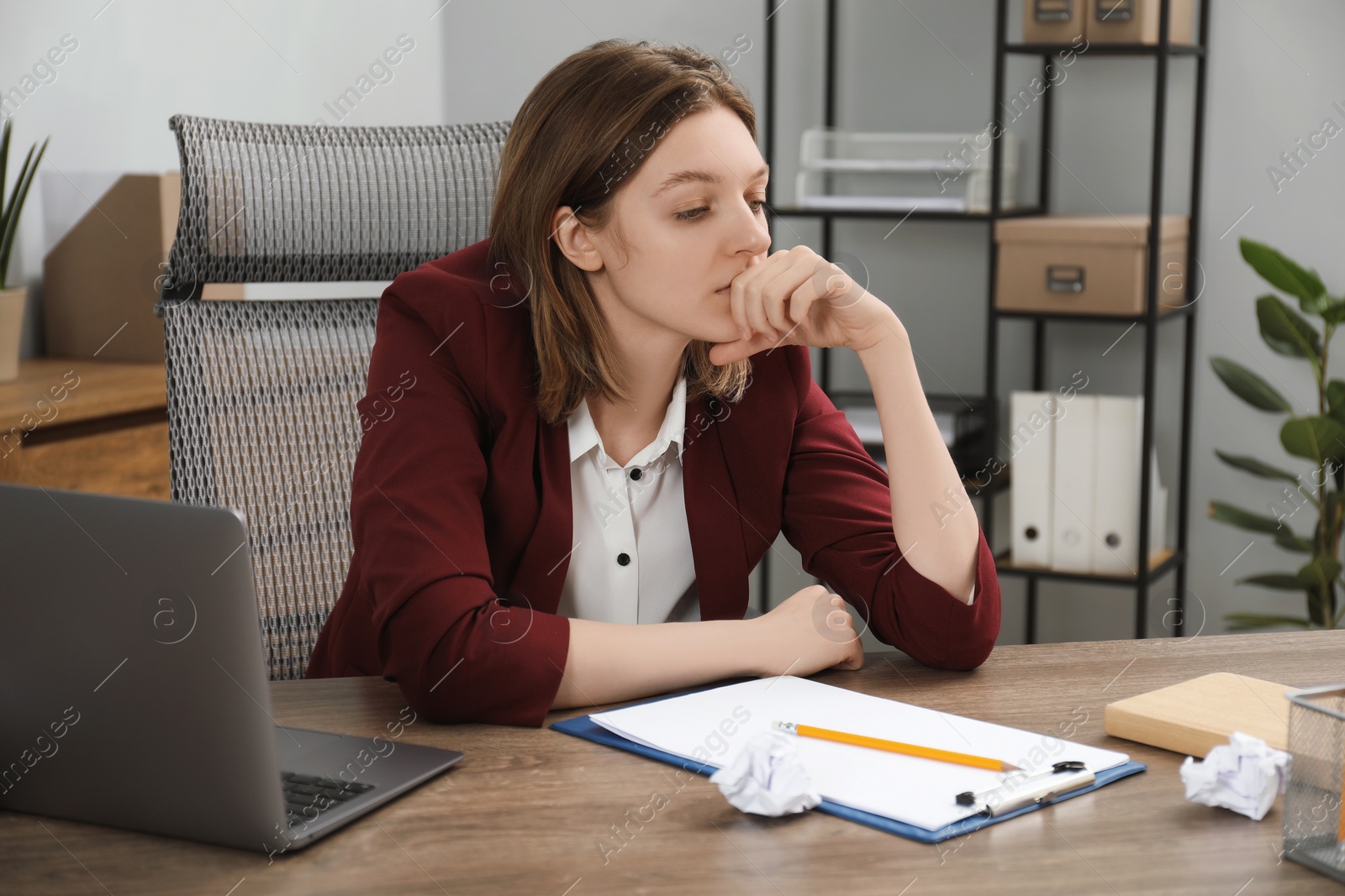 Photo of Sad businesswoman working at wooden table in office