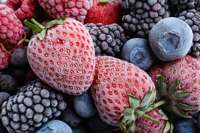 Photo of Mix of different frozen berries as background, top view