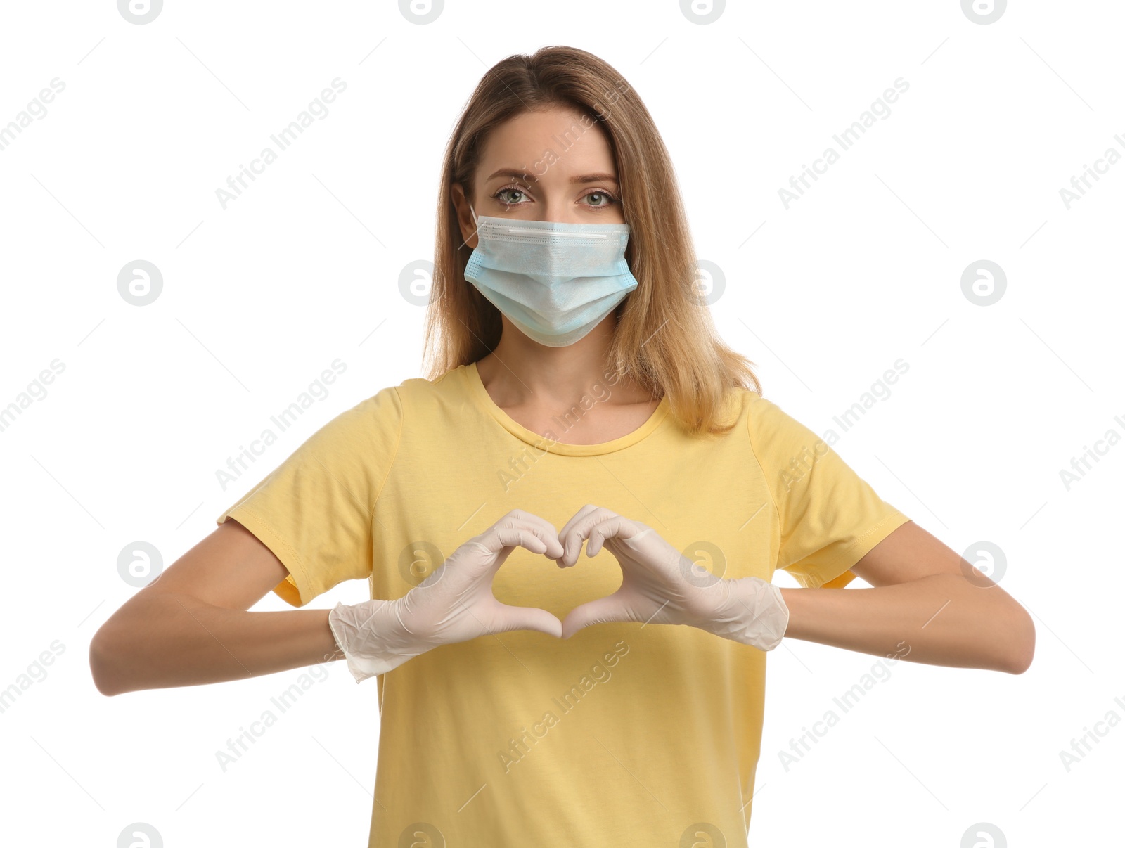 Photo of Young woman in medical gloves and protective mask making heart with hands on white background