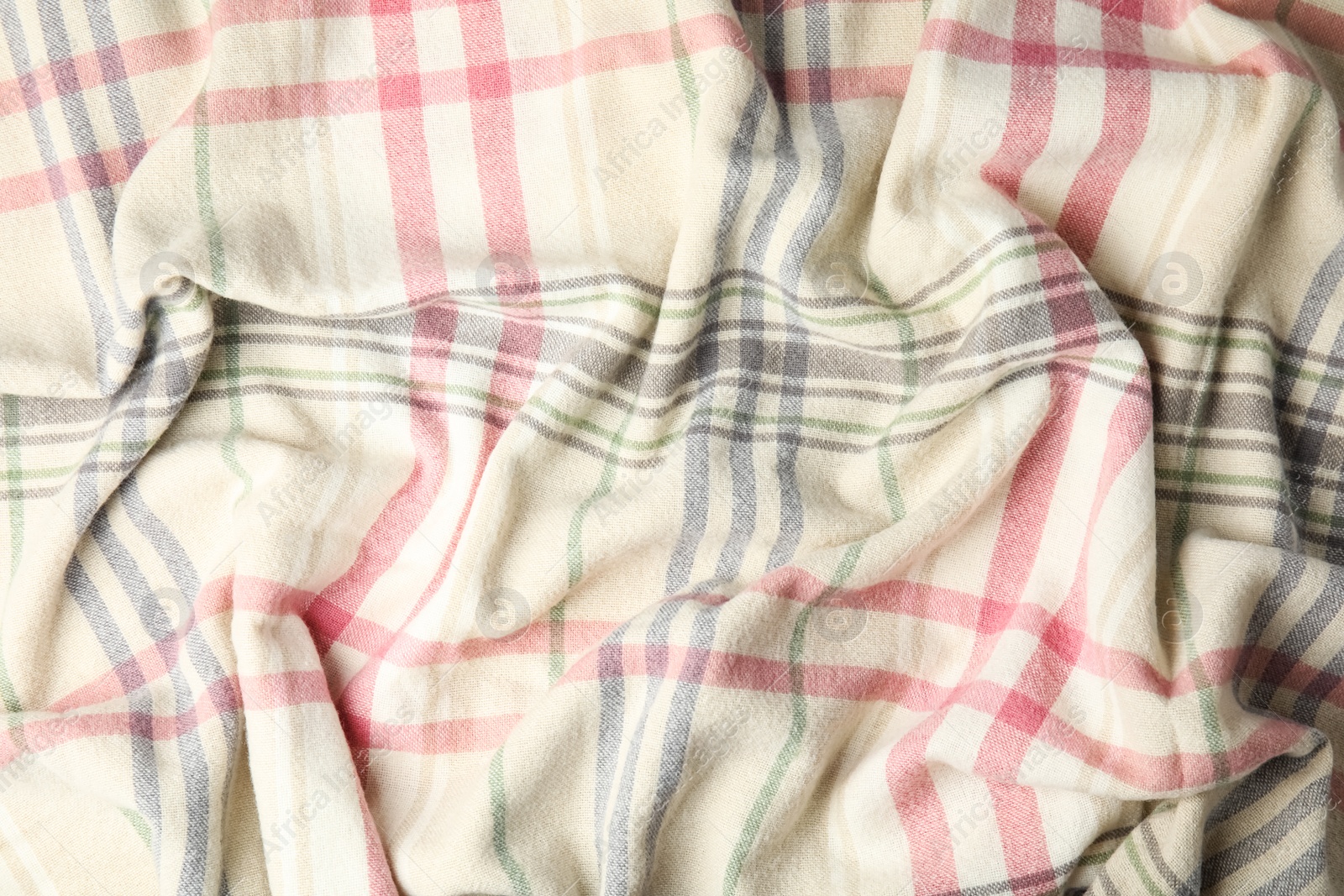 Photo of Soft crumpled checkered plaid as background, top view