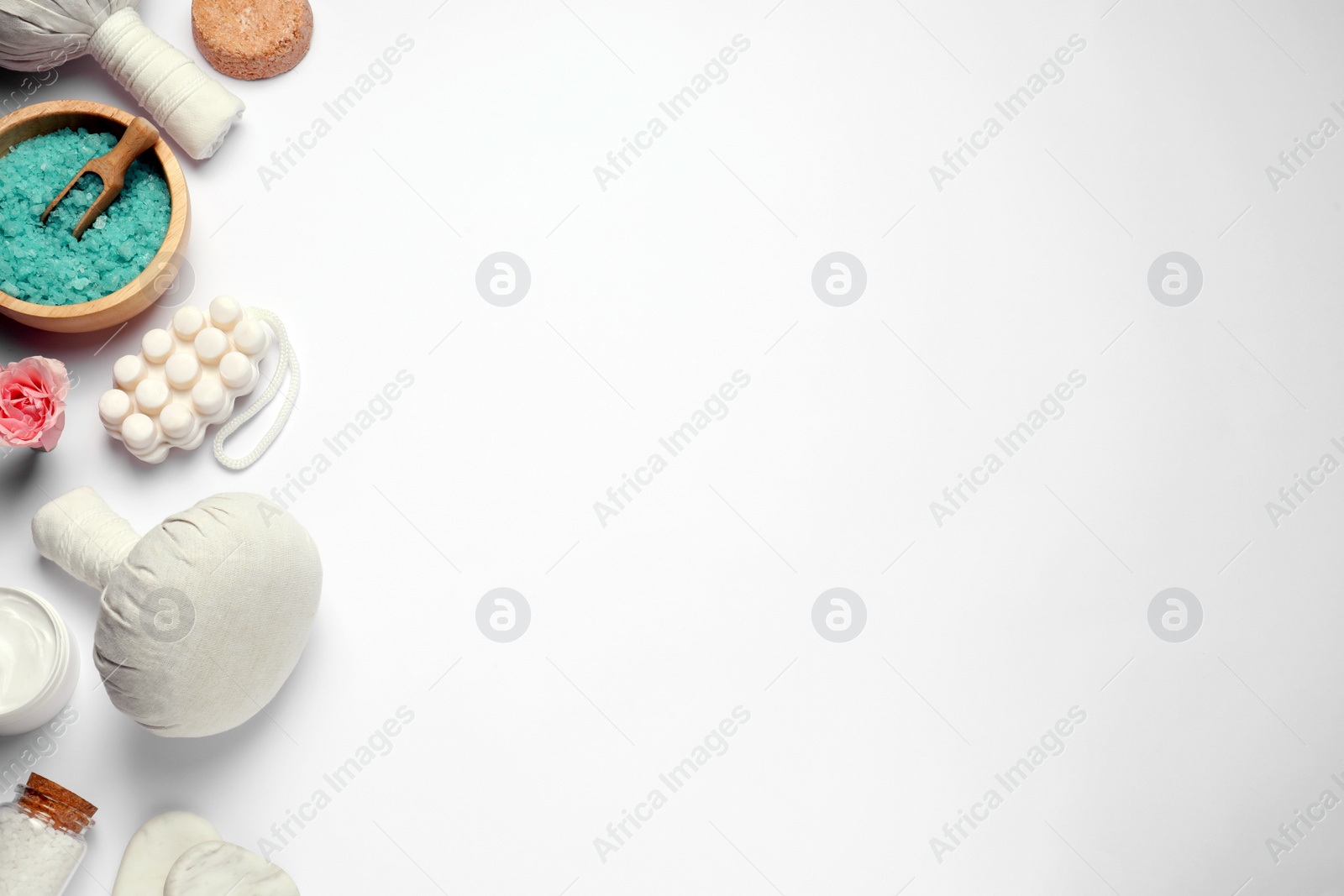 Photo of Beautiful spa composition with herbal massage bags and different care products on white background, flat lay. Space for text