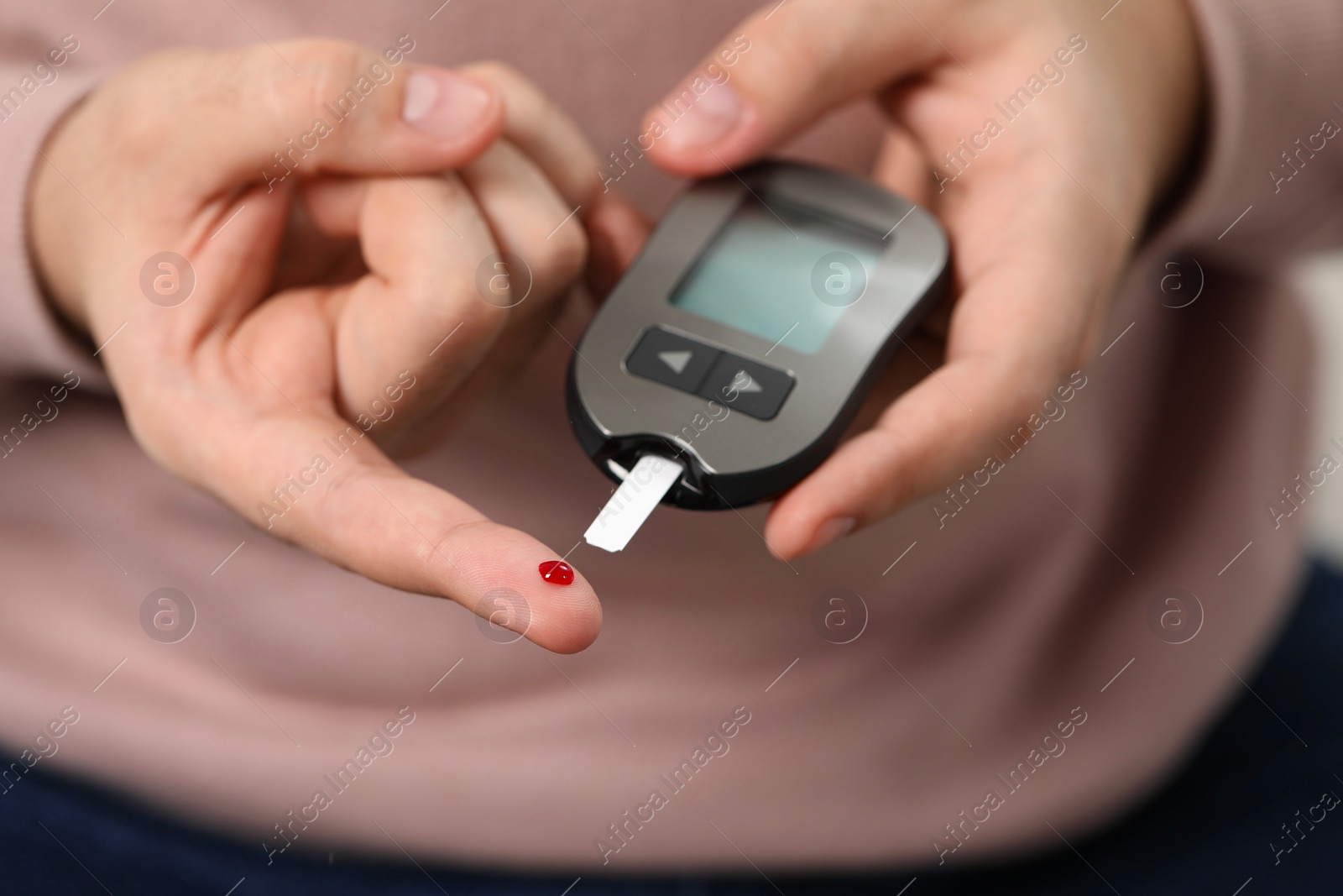 Photo of Diabetes test. Man checking blood sugar level with glucometer, closeup