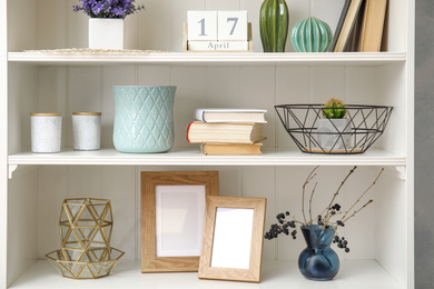 Photo of White shelving unit with books and different decorative stuff