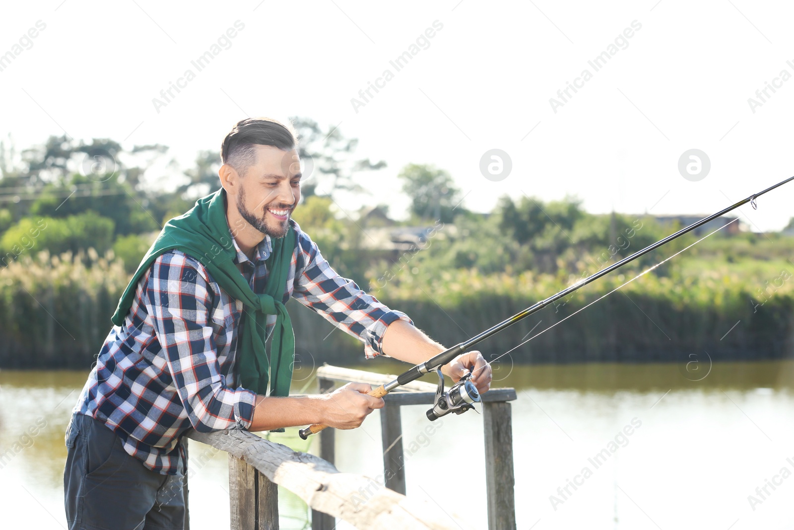 Photo of Young man fishing alone on sunny day