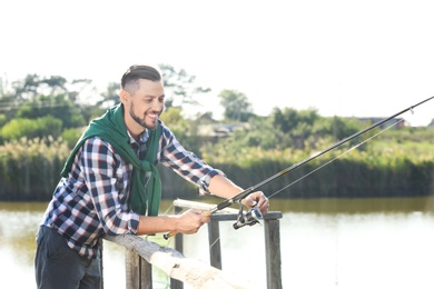 Young man fishing alone on sunny day