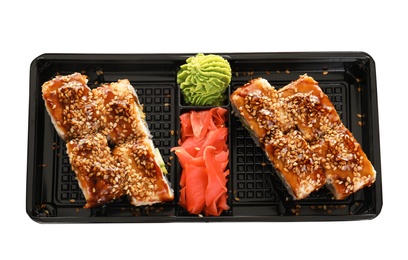 Box with tasty sushi rolls on white background, top view. Food delivery