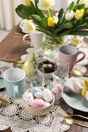 Photo of Festive table setting with beautiful flowers. Easter celebration