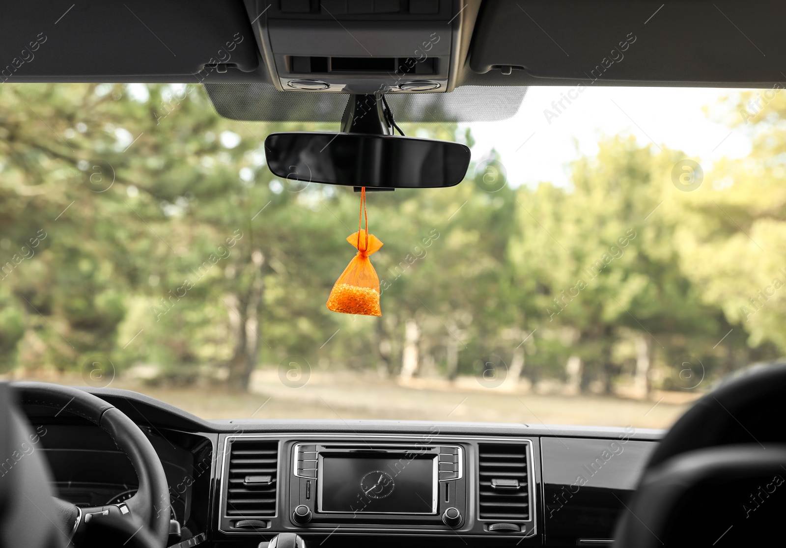 Photo of Air freshener hanging on rear view mirror in car