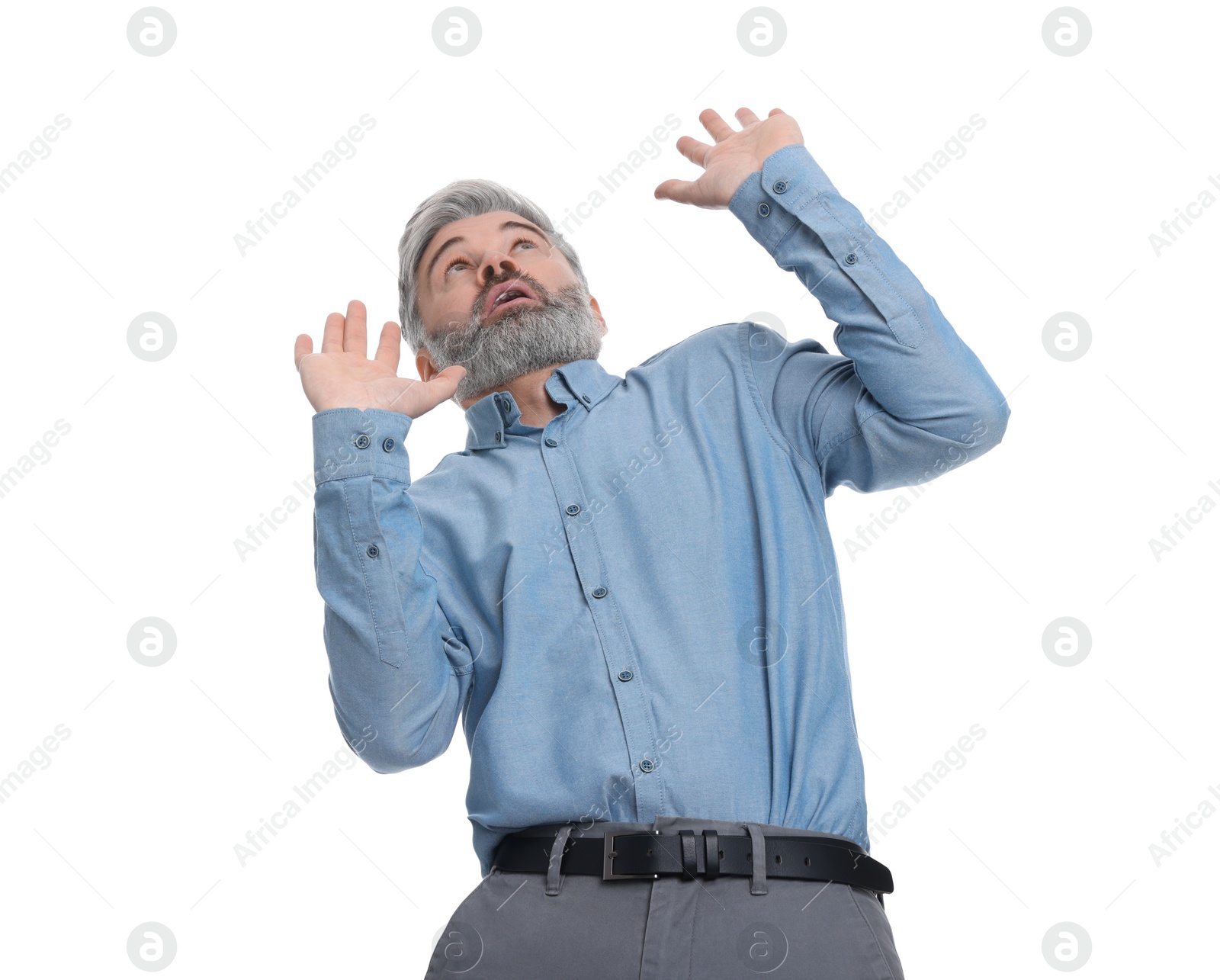 Photo of Mature businessman in stylish clothes avoiding something on white background