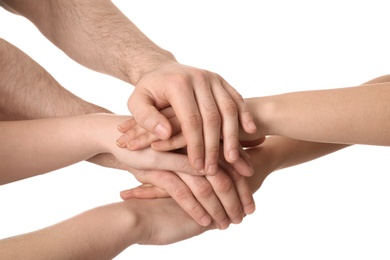 Photo of Young people putting their hands together on white background, closeup