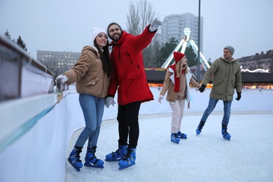 Group of friends at outdoor ice skating rink