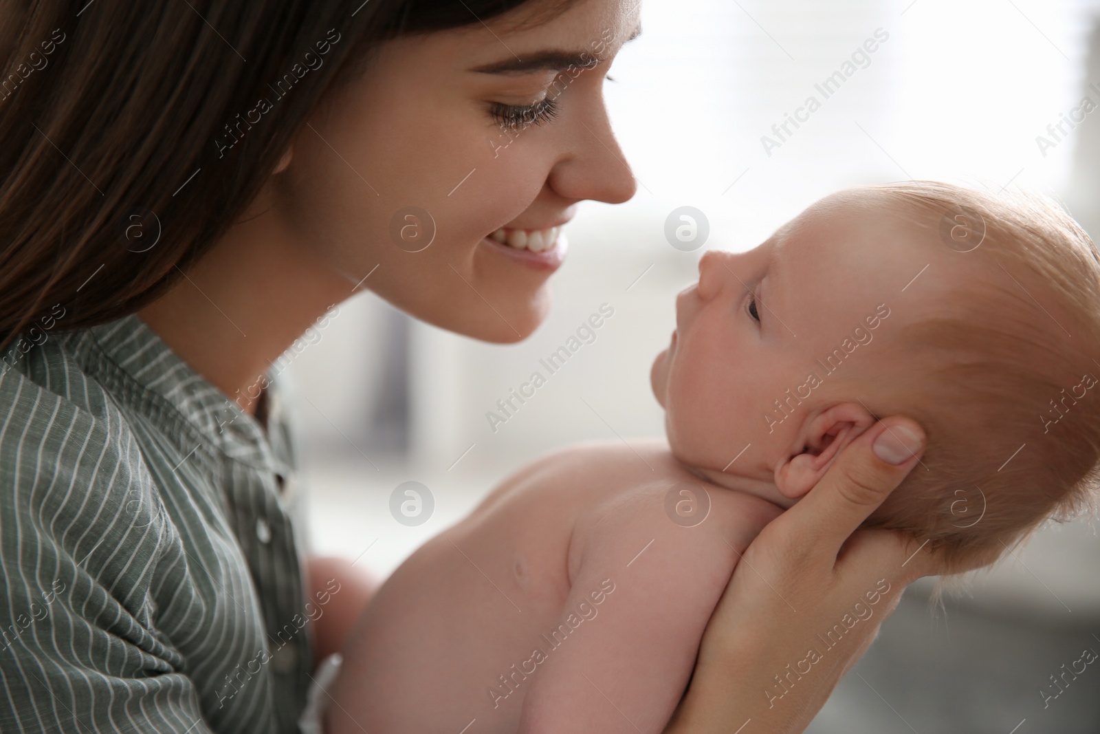 Photo of Mother with her newborn baby at home, closeup