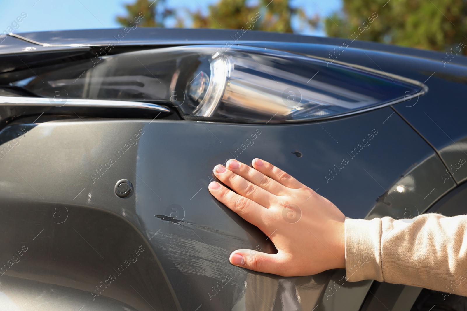 Photo of Man near car with scratch, closeup view