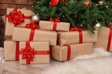 Photo of Beautiful Christmas tree and gift boxes in room