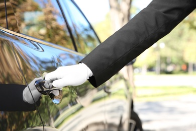 Photo of Driver opening car door, closeup. Chauffeur service