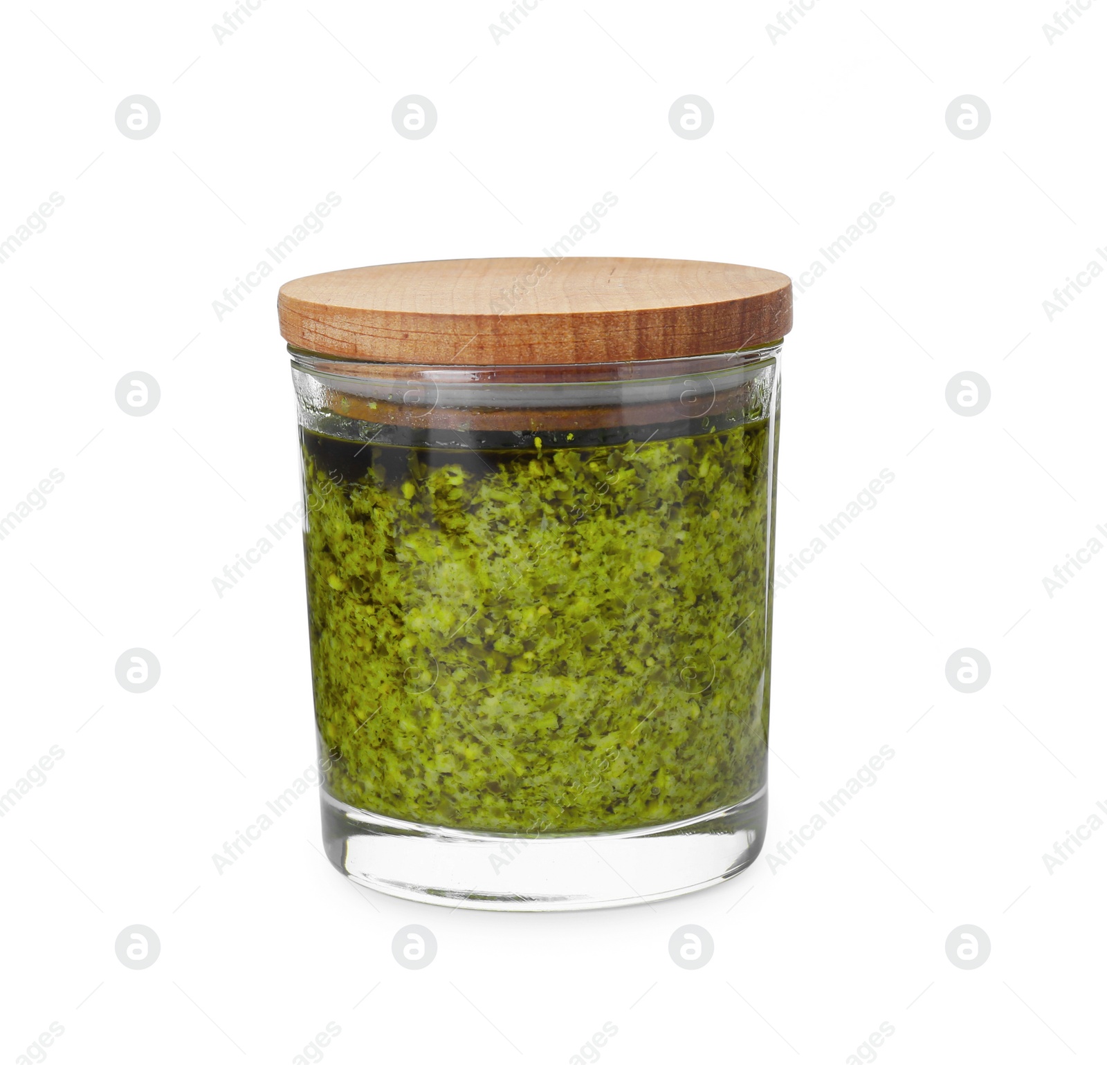 Photo of Tasty pesto sauce in glass jar isolated on white