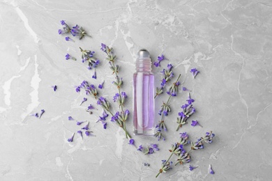 Flat lay composition with natural lavender essential oil on marble table